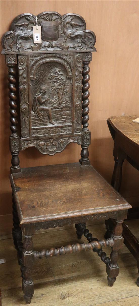 A late 19th century oak hall chair, carved with a fisherman